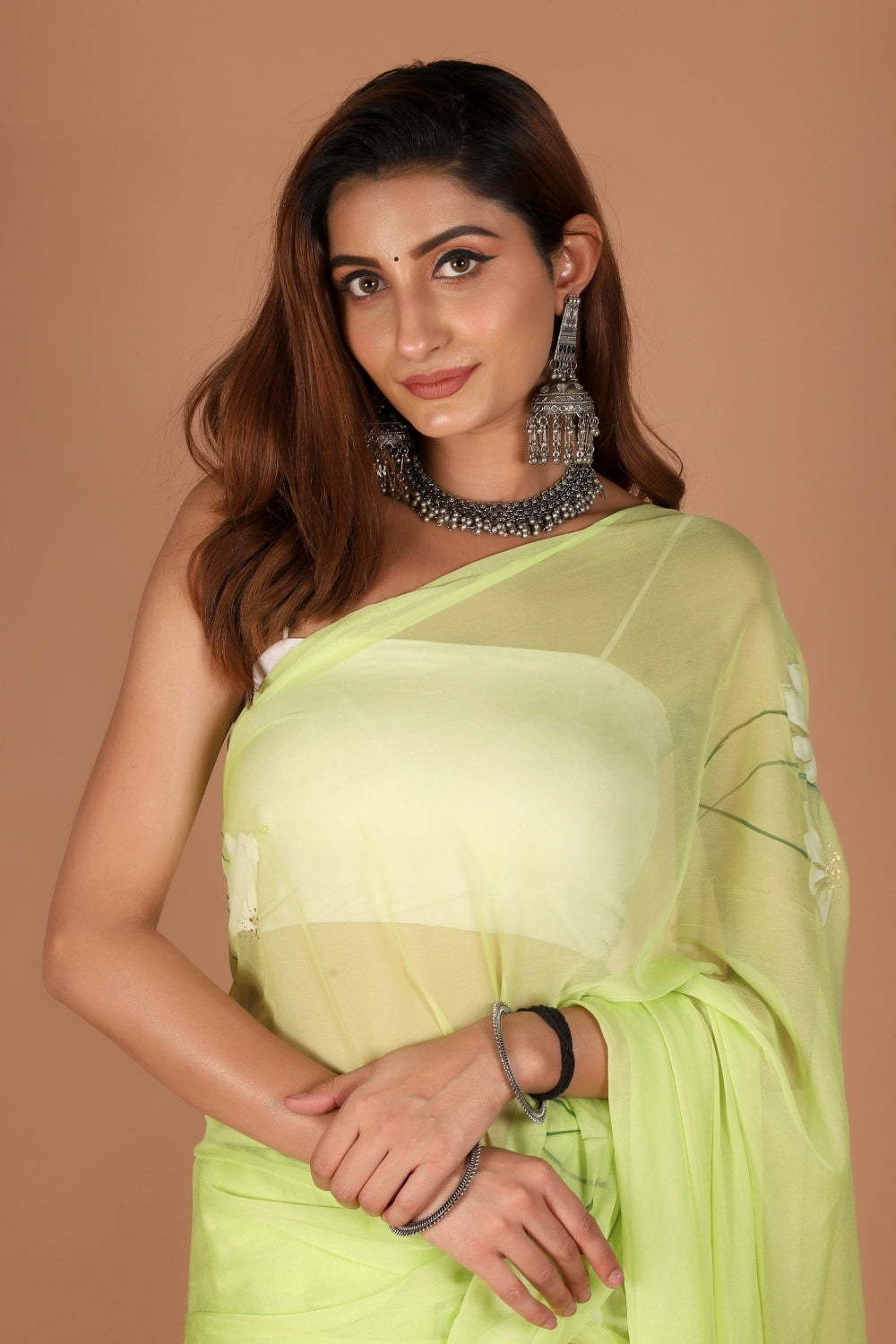 Model wearing pastel green chiffon hand-painted saree for Rakhi