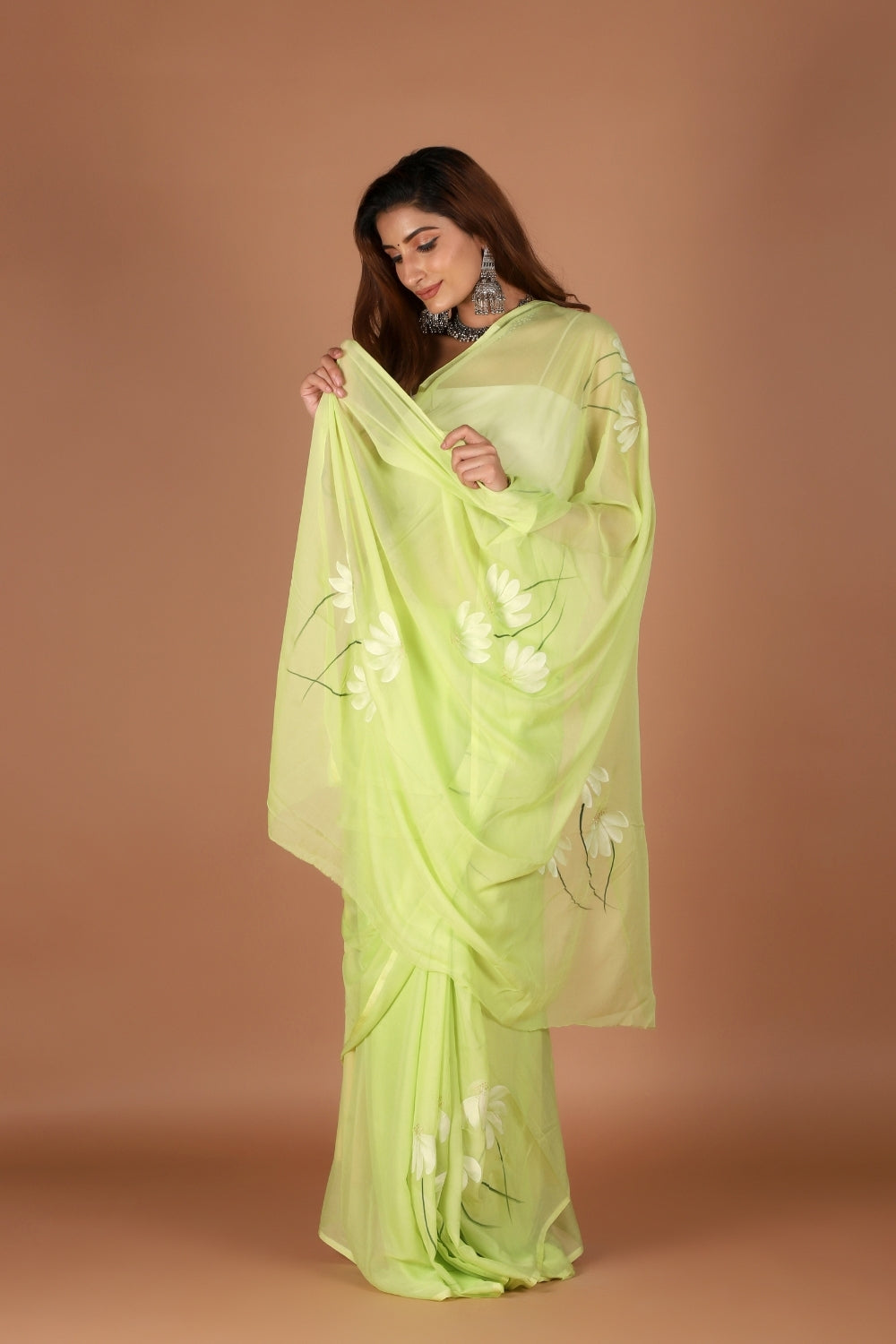Model wearing pastel green chiffon hand-painted saree for Rakhi