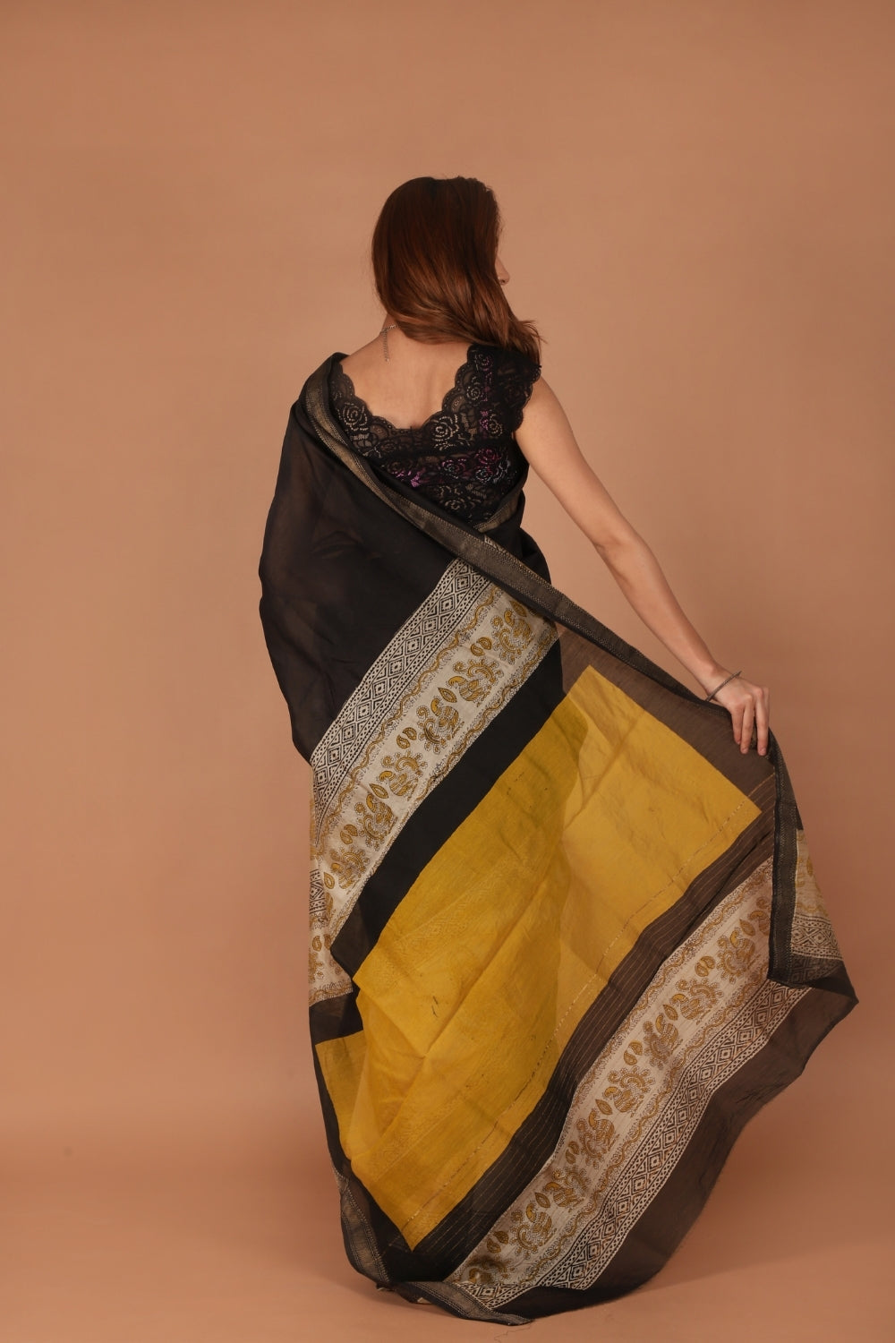 Model in black Chanderi saree with beige hand block print details