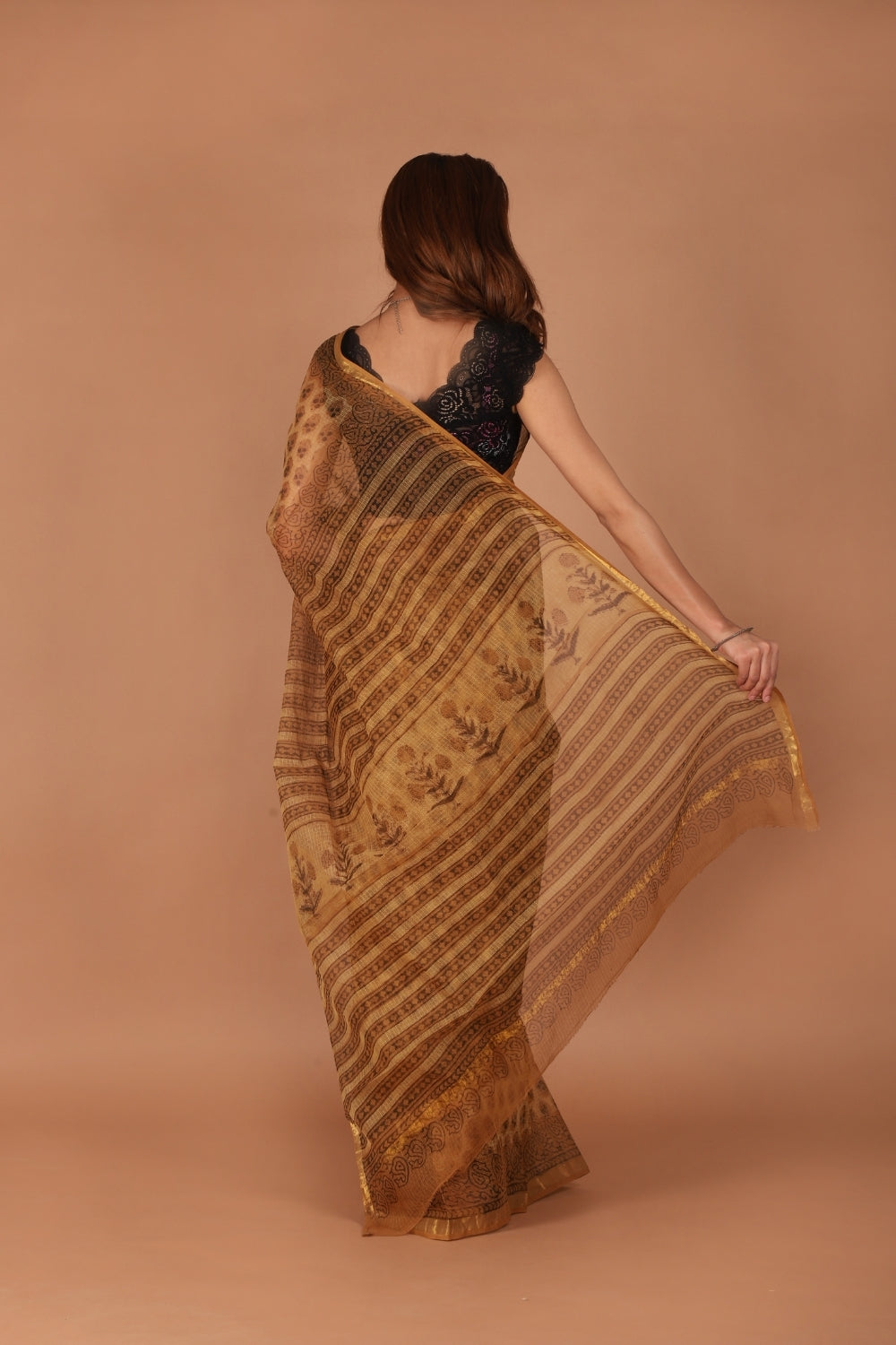 Model in golden Kota Doria saree with zari border and block print