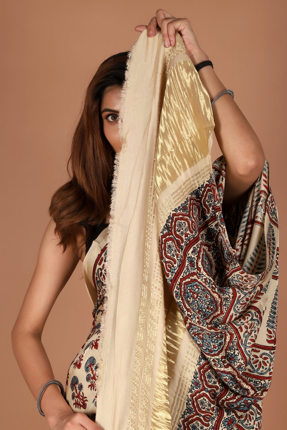 Model wearing modal silk saree with Ajrakh print and zari palla
