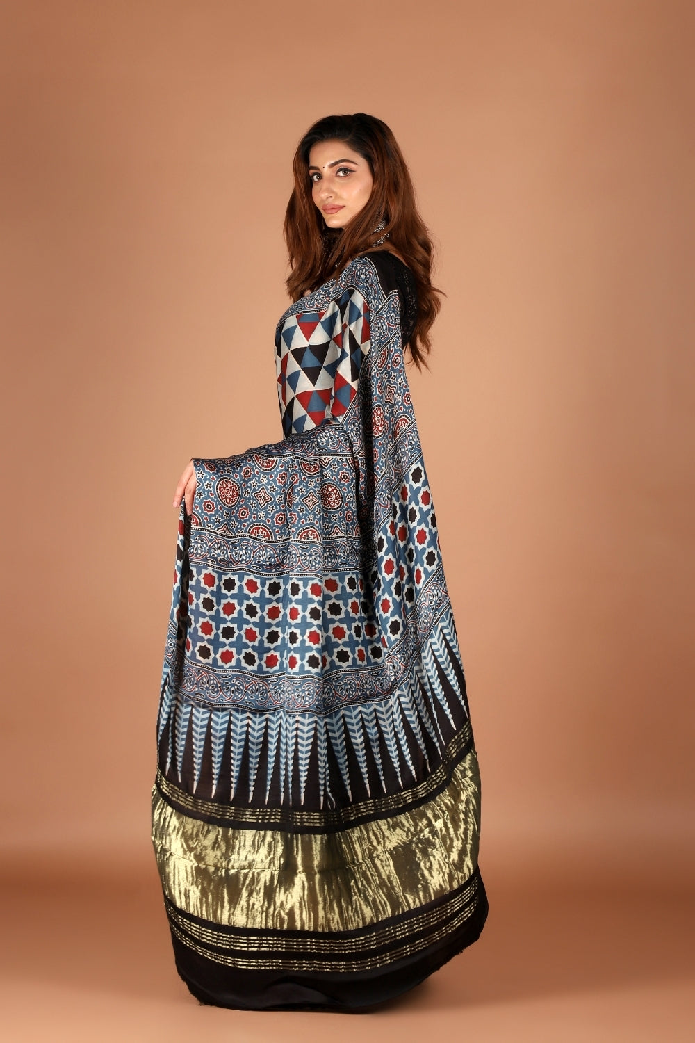 Woman draped in black modal silk Ajrakh saree with zari palla