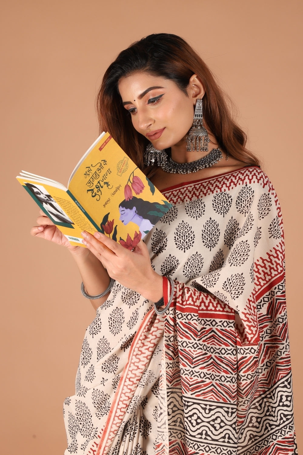Beige mull cotton saree with black hand block prints and rust red border