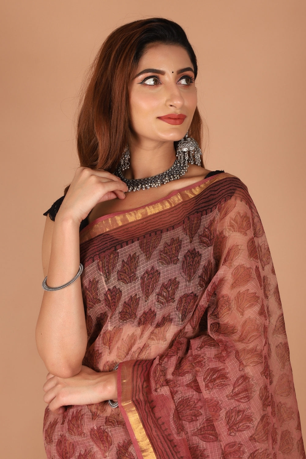 Model in rosewood Kota Doria saree with golden zari border