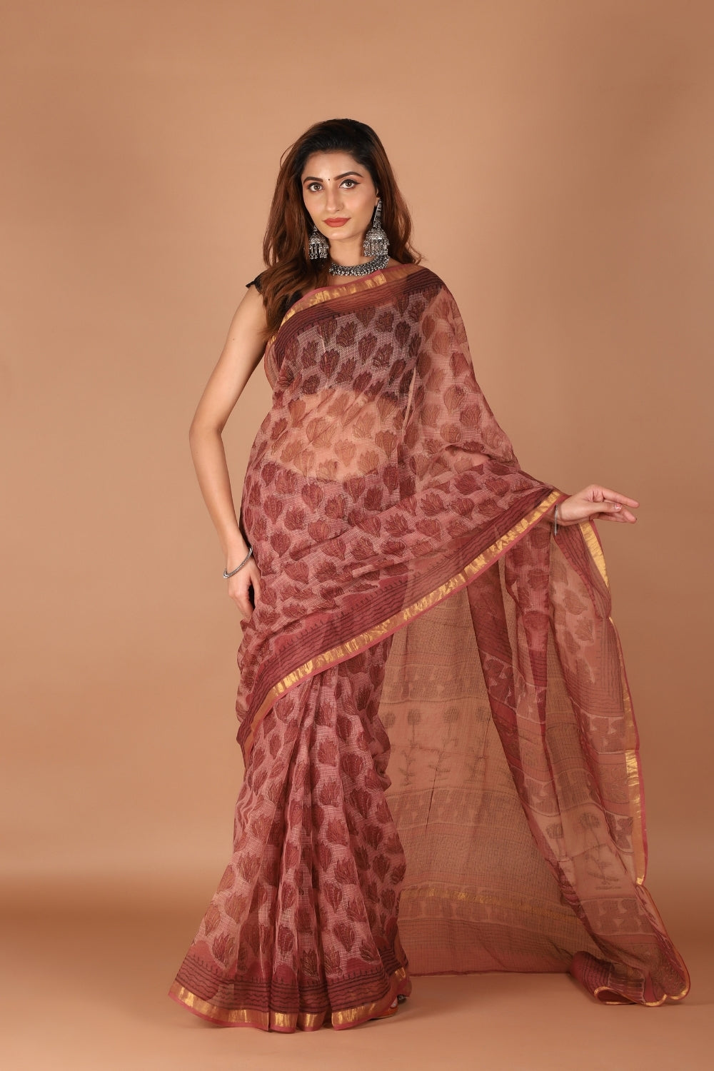 Model in rosewood Kota Doria saree with golden zari border