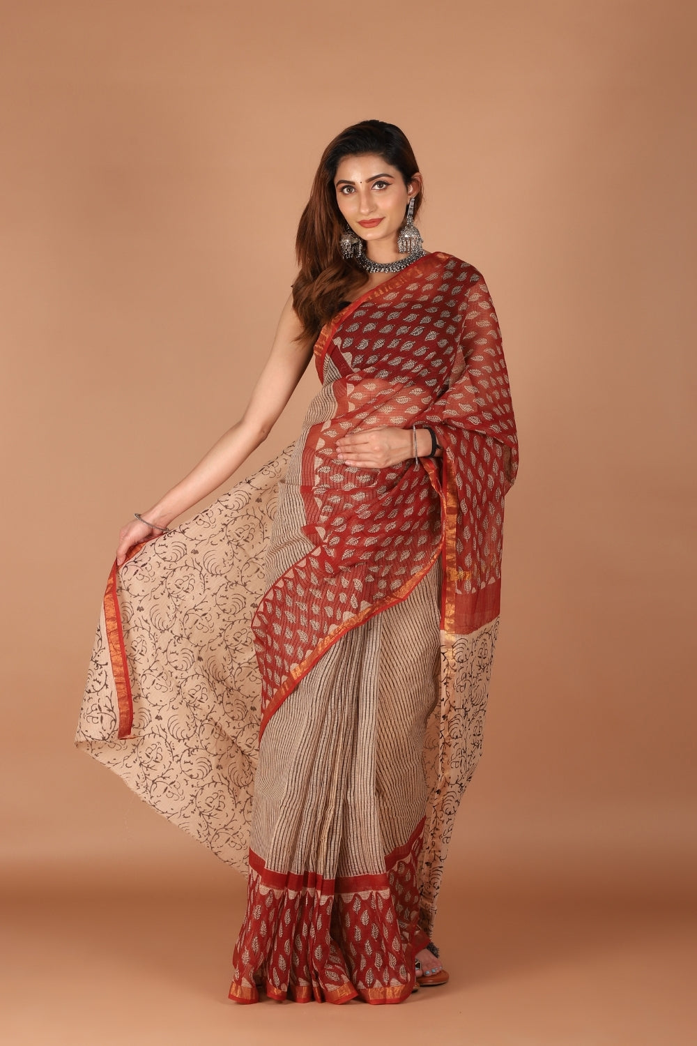 Model wearing dual-tone Kota Doria saree with red zari border