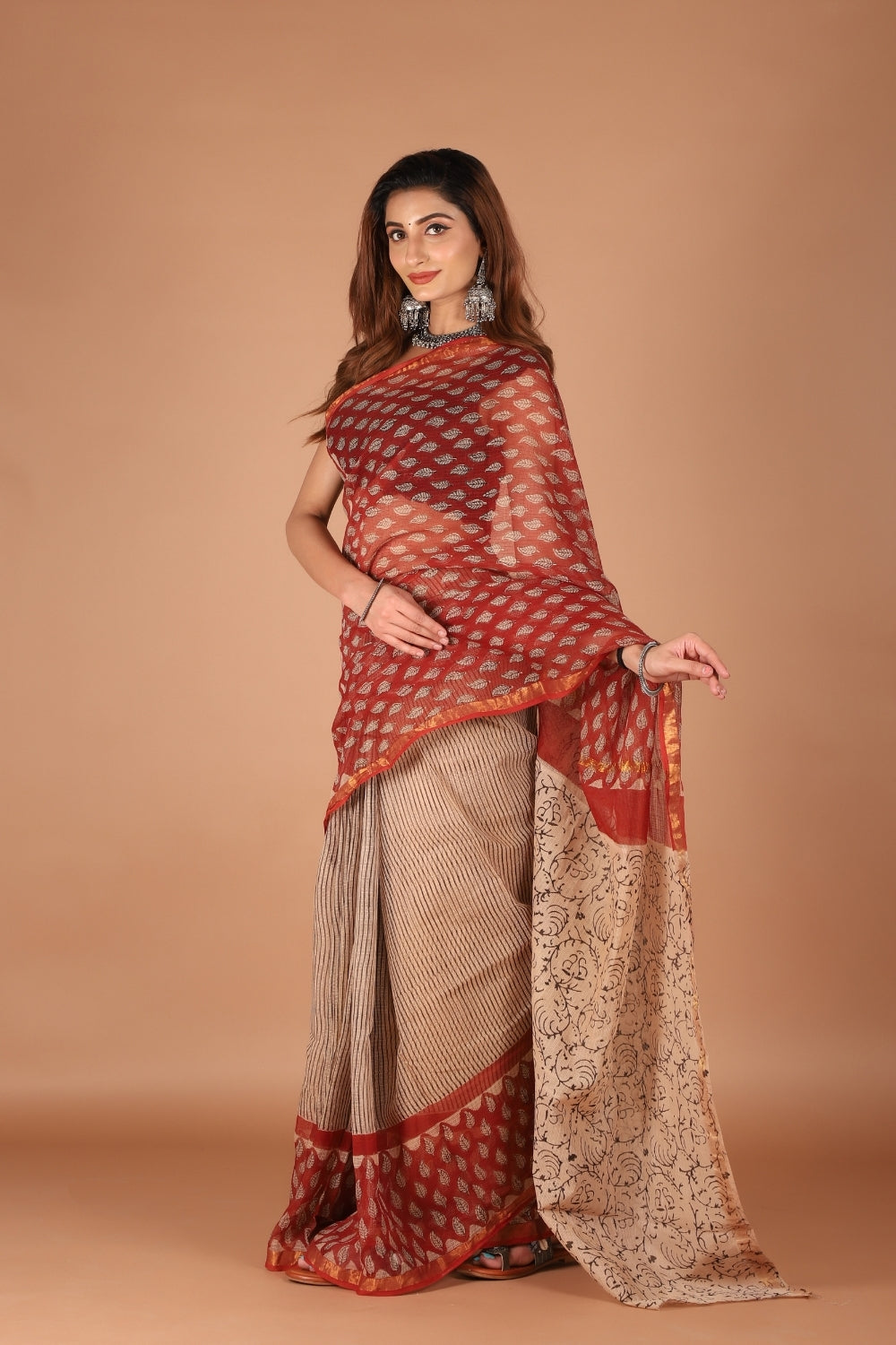 Model wearing dual-tone Kota Doria saree with red zari border