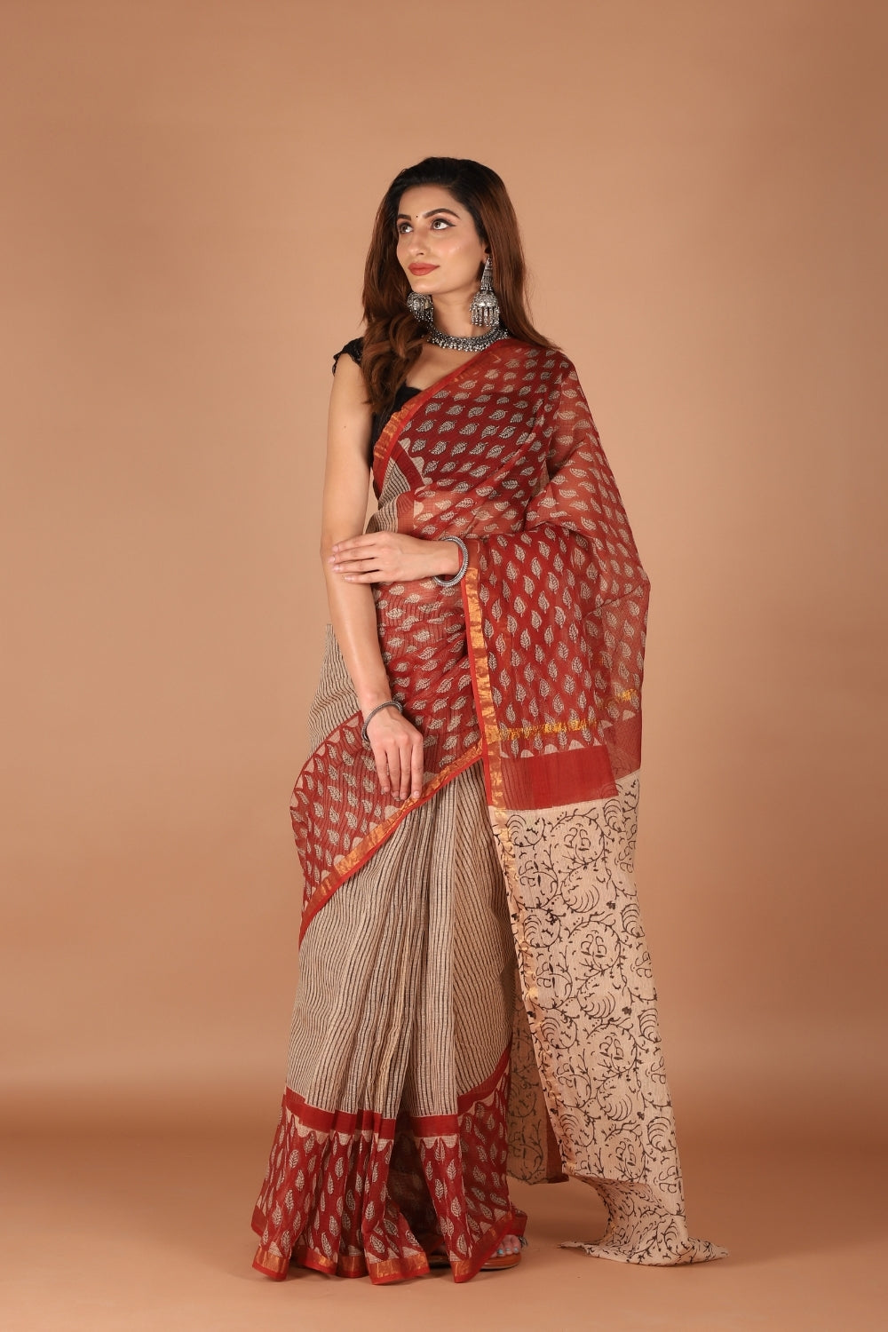 Model wearing dual-tone Kota Doria saree with red zari border