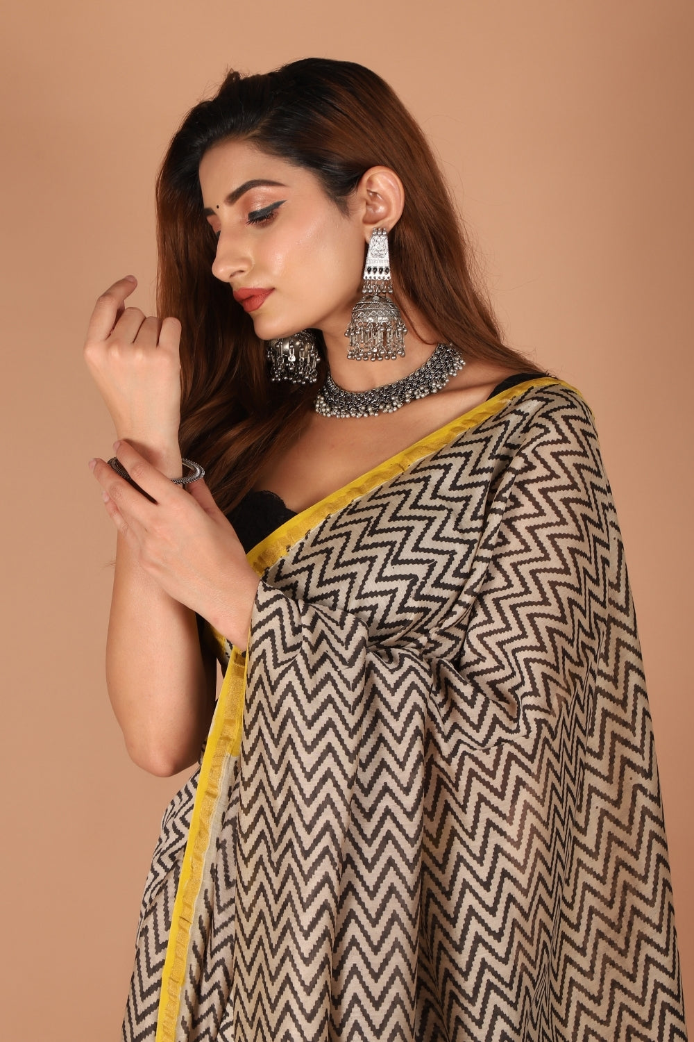 Model wearing monochrome Chanderi silk saree with yellow border