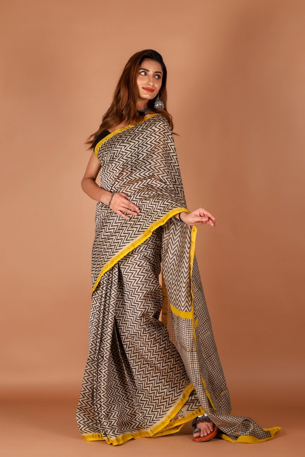 Model wearing monochrome Chanderi silk saree with yellow border