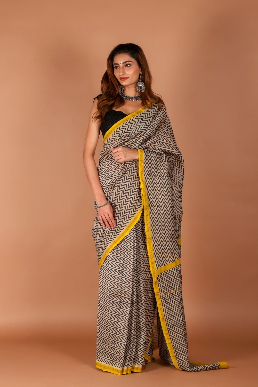 Model wearing monochrome Chanderi silk saree with yellow border