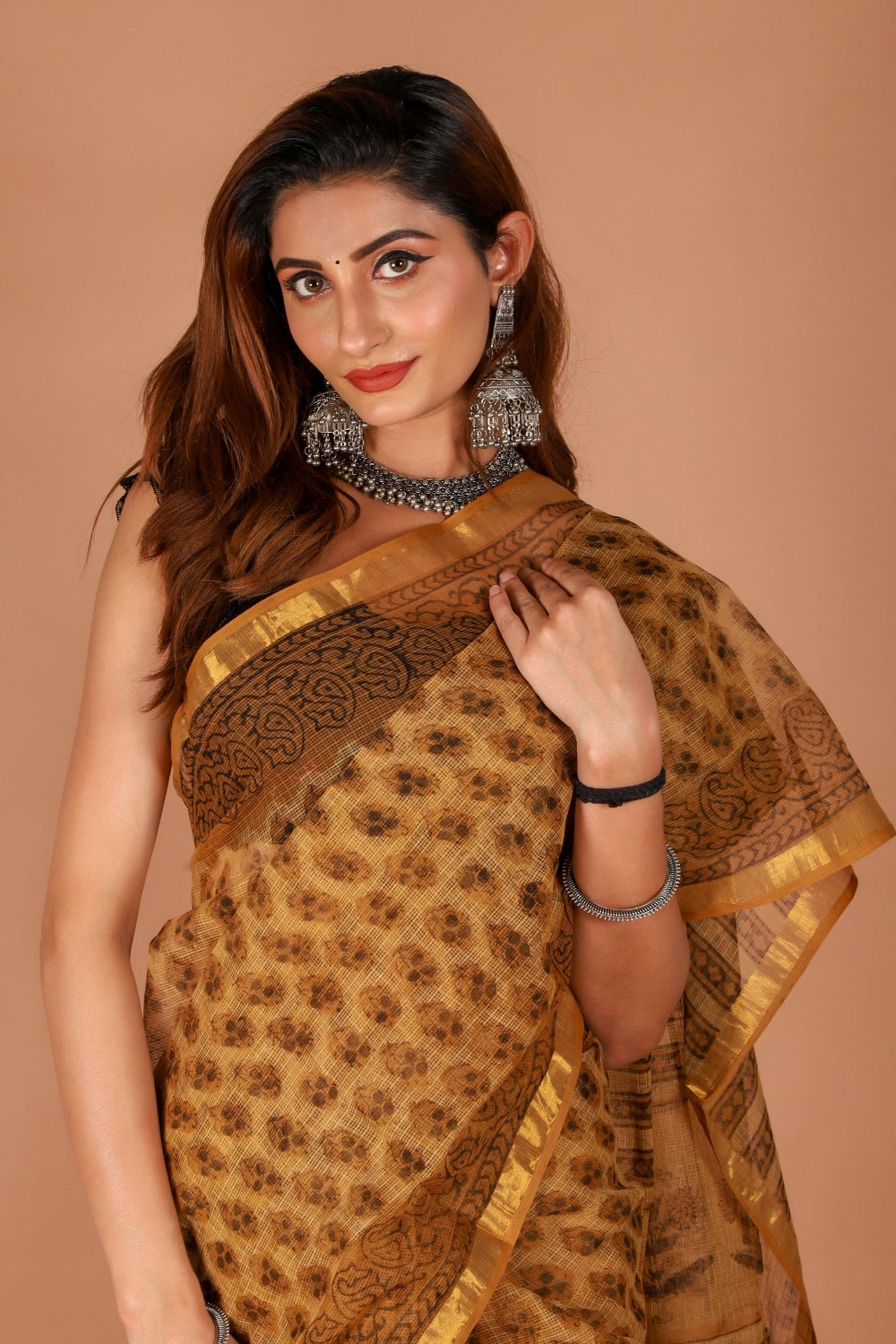 Model in golden Kota Doria saree with zari border and block print