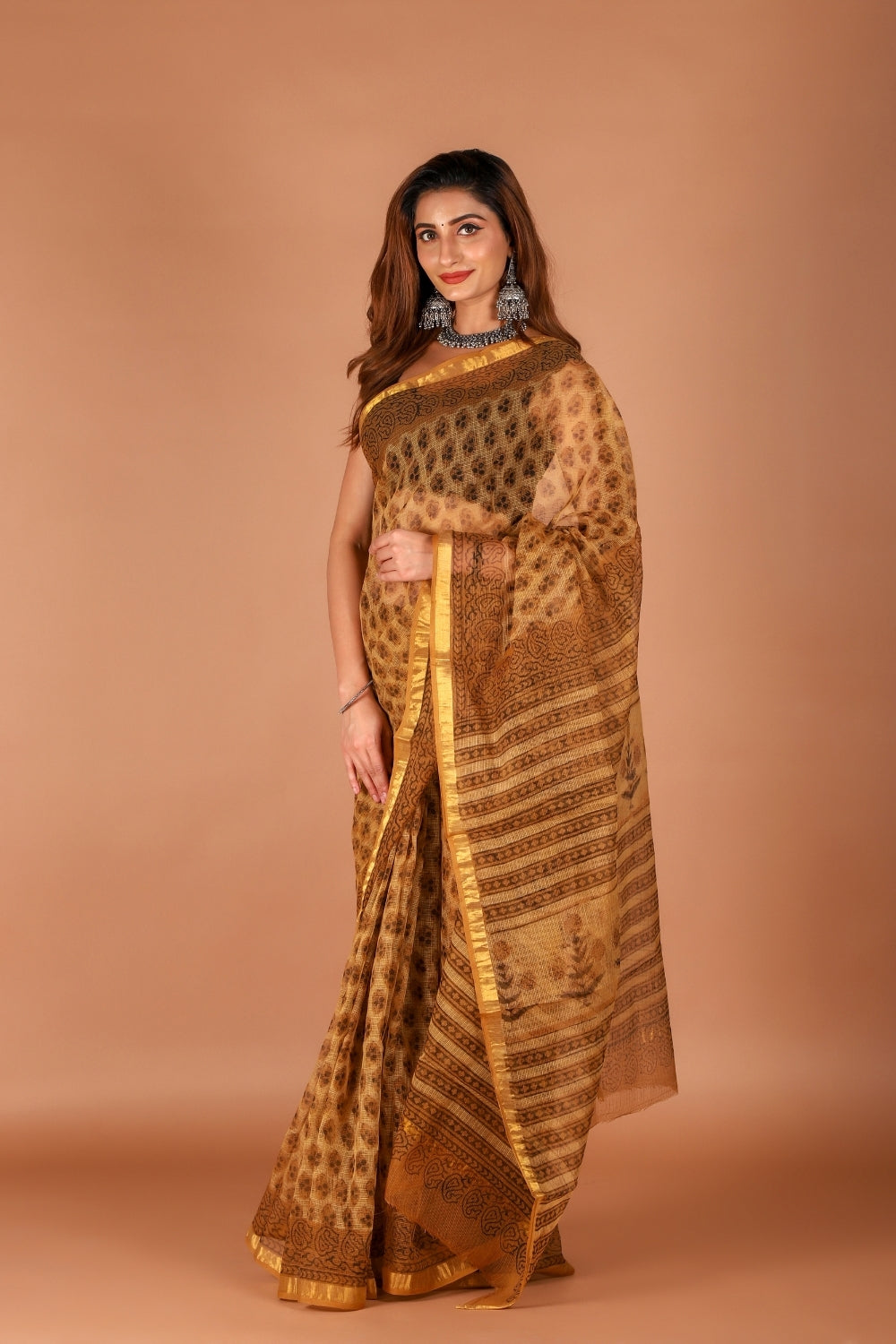 Model in golden Kota Doria saree with zari border and block print