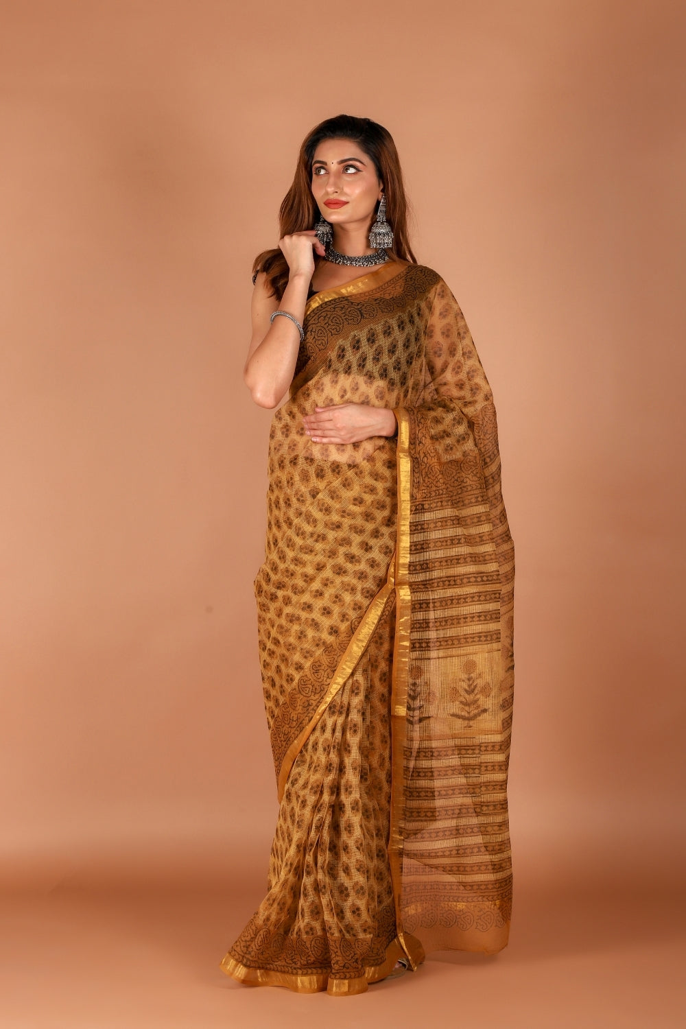 Model in golden Kota Doria saree with zari border and block print