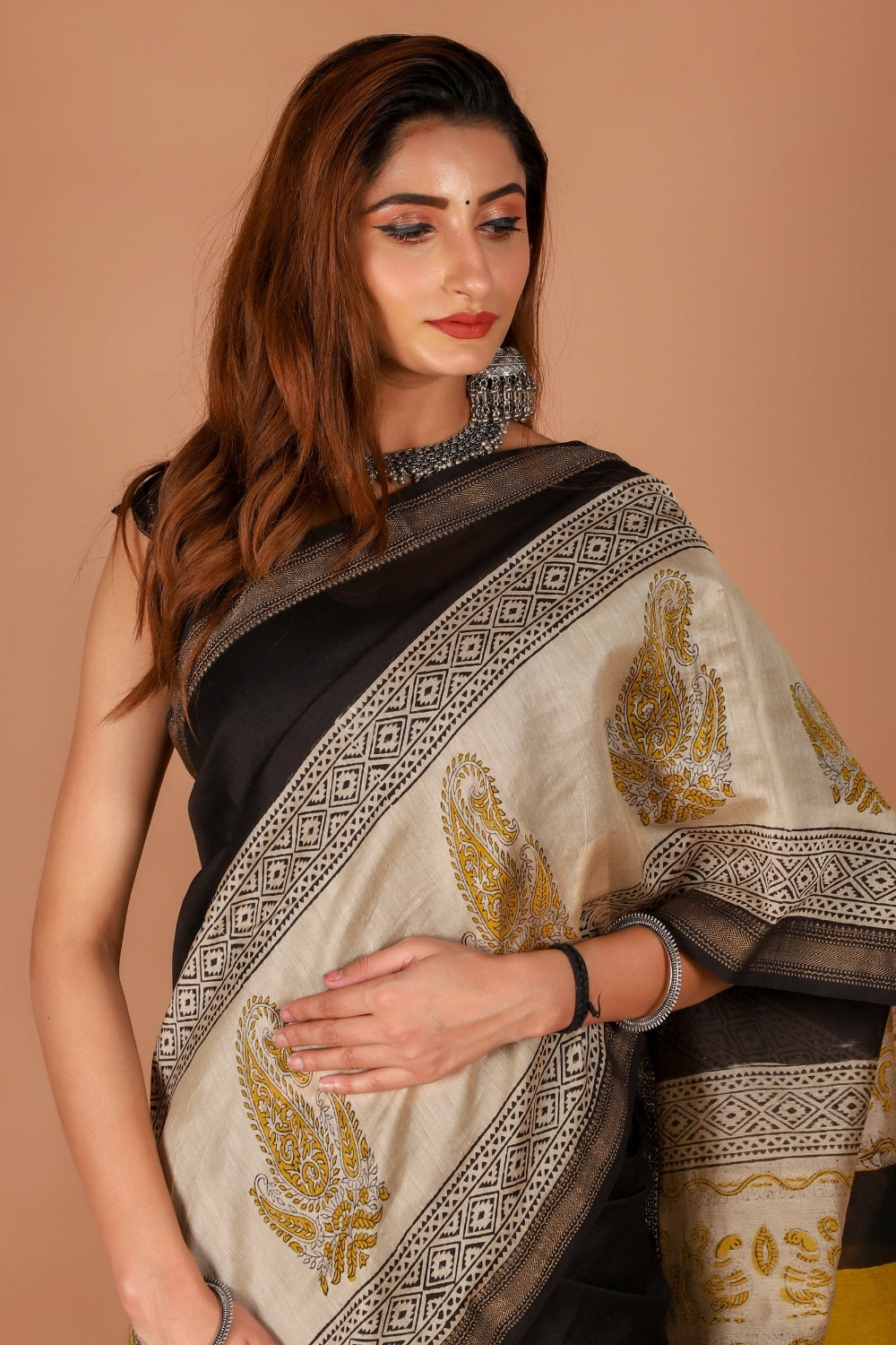 Model in black Chanderi saree with beige hand block print details