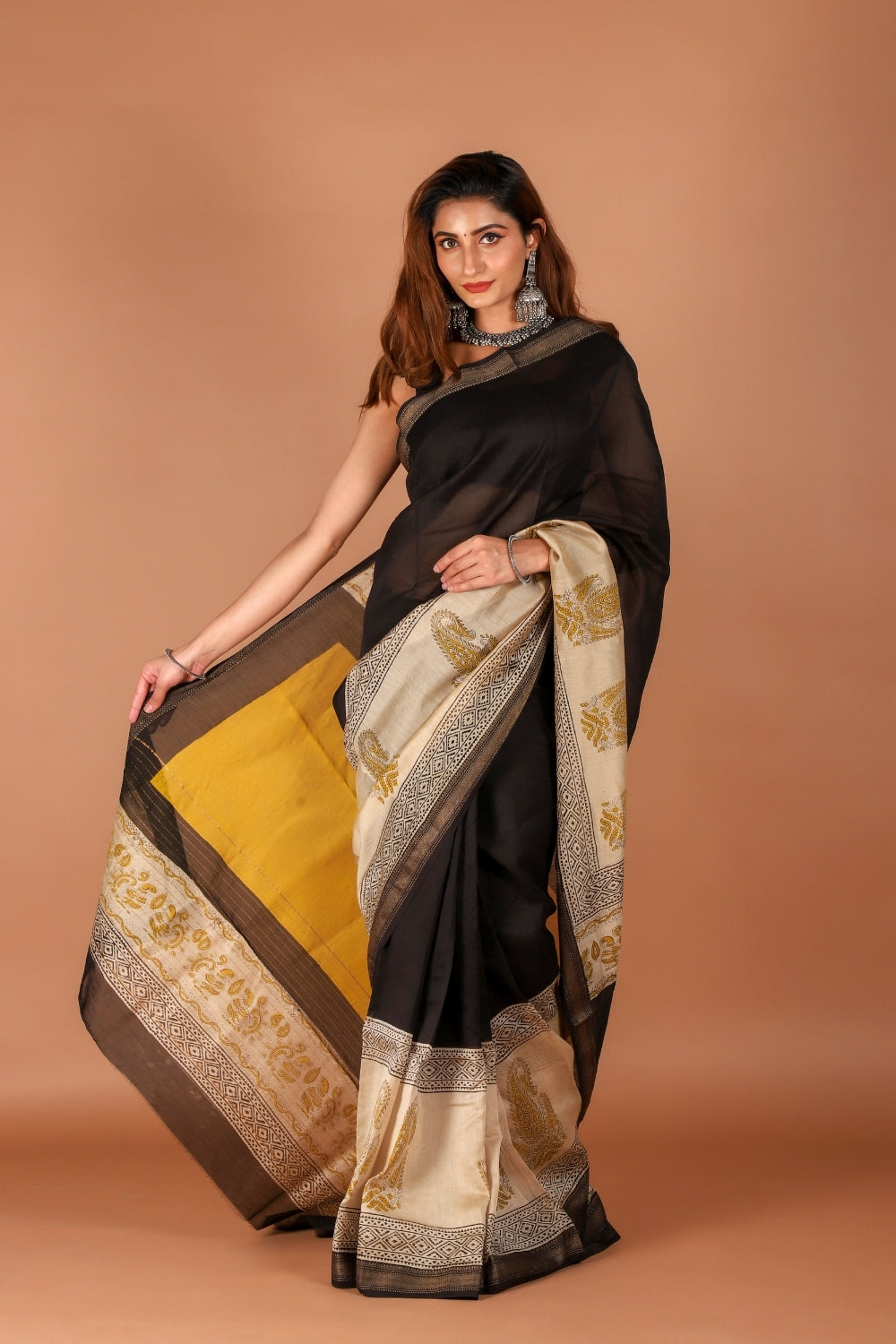 Model in black Chanderi saree with beige hand block print details